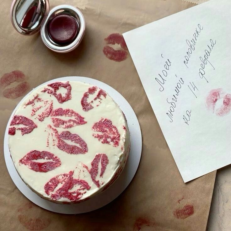 a piece of paper with lipstick on it next to a cake