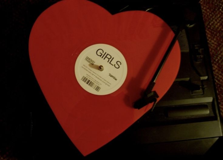 a red heart with the word girls on it