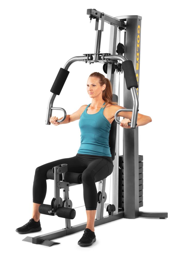 a woman is doing squats on a seated bench in front of a gym machine