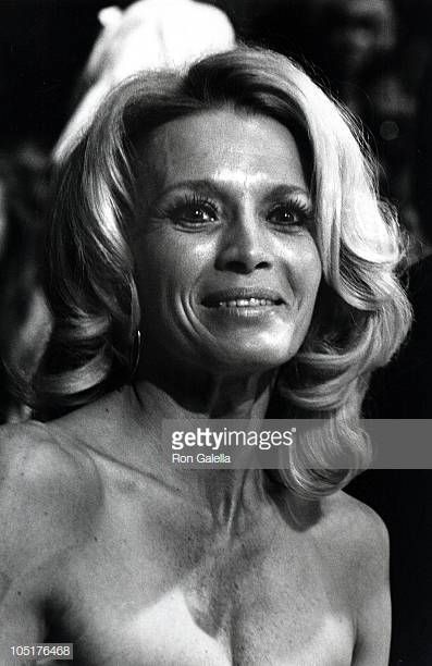 an older woman posing for the camera in black and white