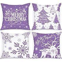 four purple and white christmas pillows with snowflakes on them