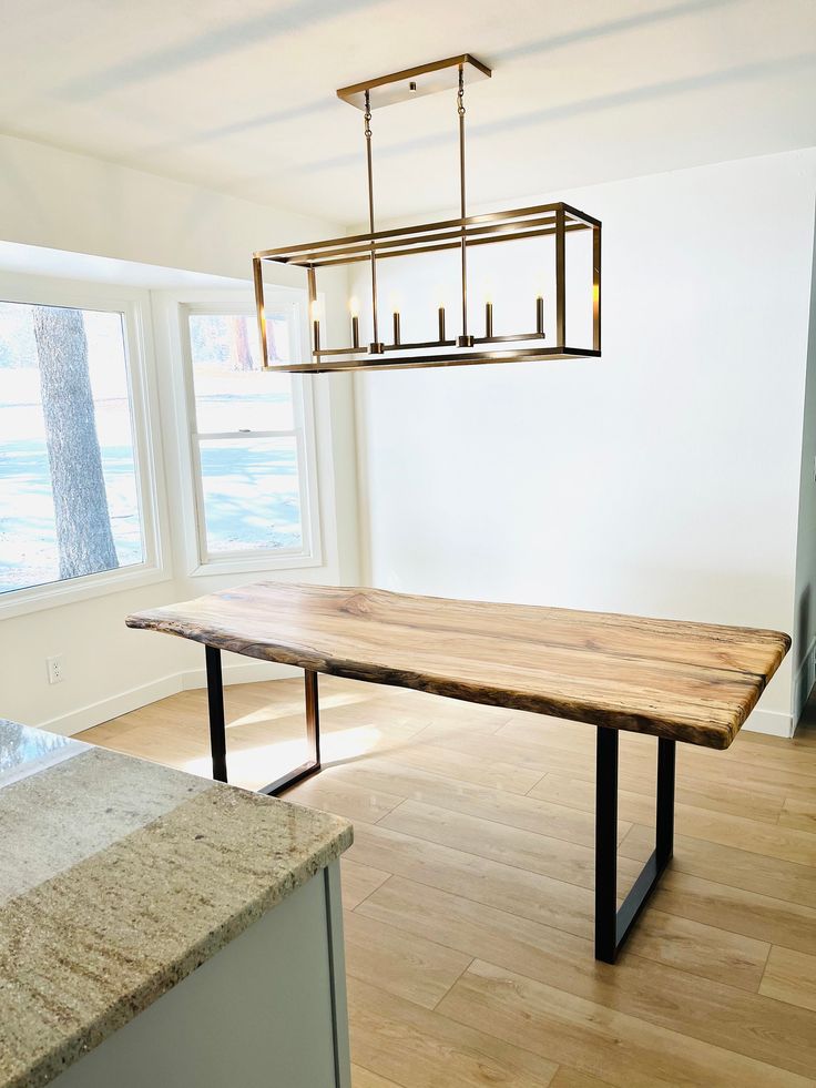 a wooden table sitting in the middle of a kitchen