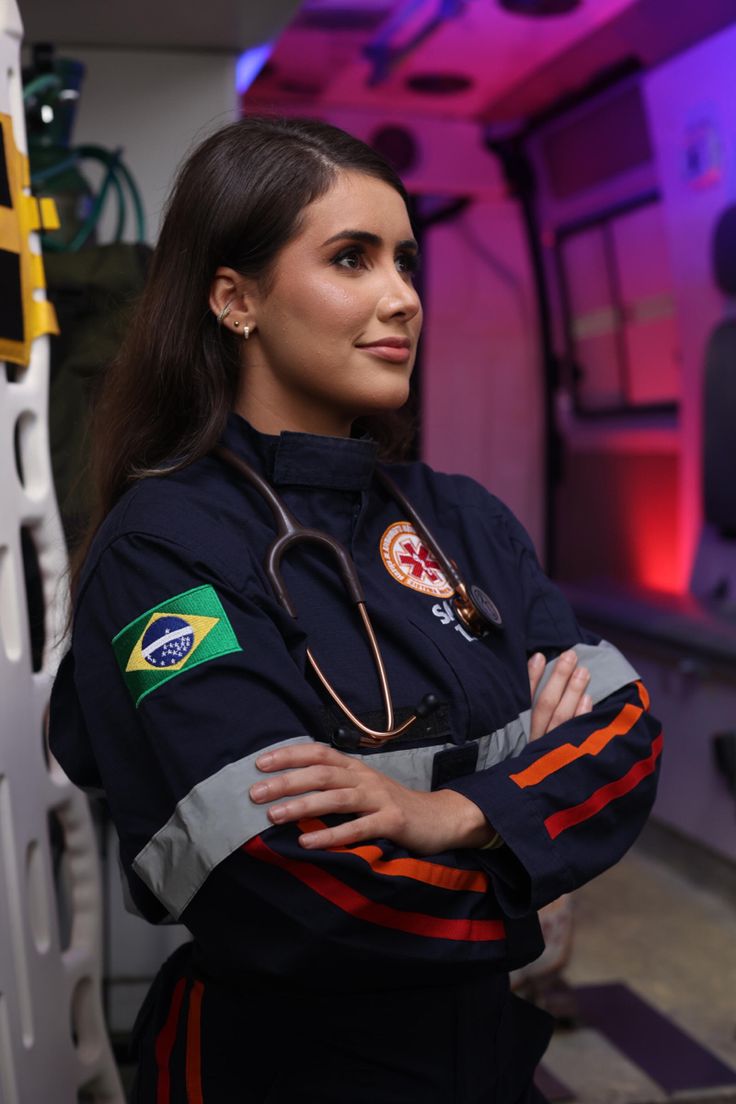 a woman in uniform standing with her arms crossed