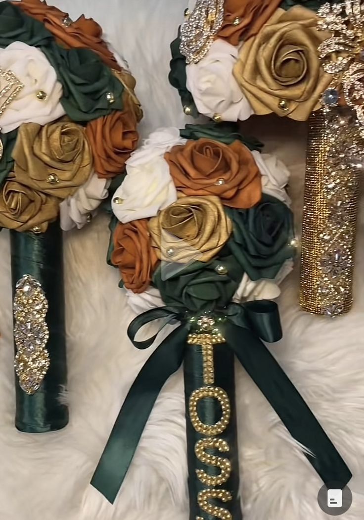 two bridal bouquets with gold, green and white flowers are on a furnishing