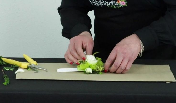 a person cutting flowers with scissors on a table