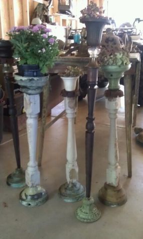 three vases with flowers on them are sitting in the middle of a room next to a table