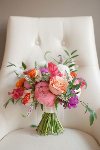 a bouquet of flowers sitting on top of a white chair