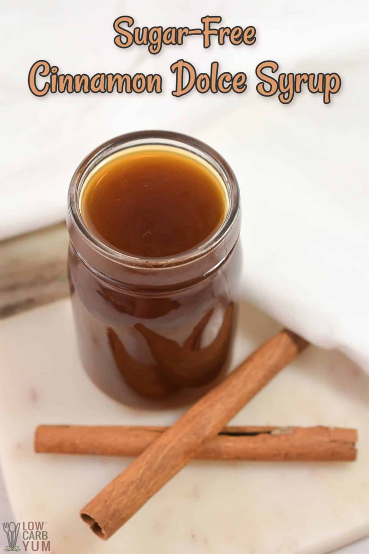 cinnamon dole syrup in a glass jar next to two cinnamon sticks