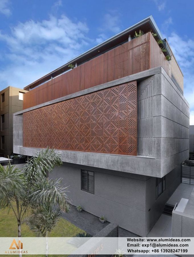 an architecturally designed building with wooden slats on the side and palm trees in front