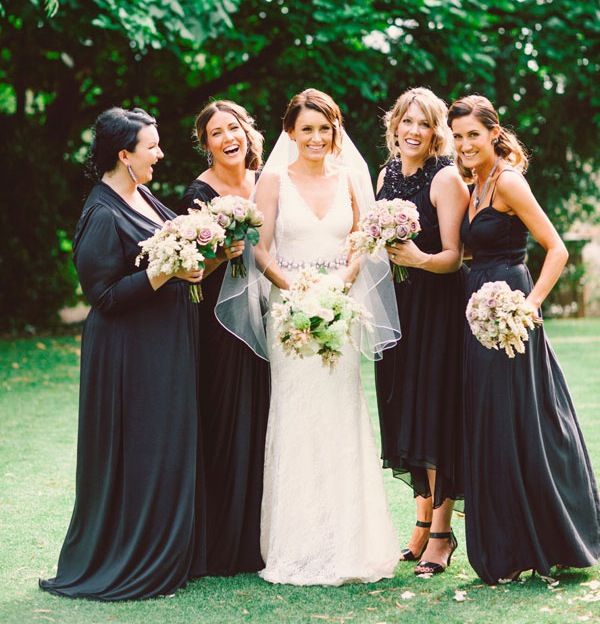 a group of women standing next to each other on top of a lush green field