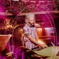 a man that is standing in front of a dj's turntable and mixing