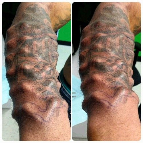 a man's arm with tattoos on it and the other side of his arm