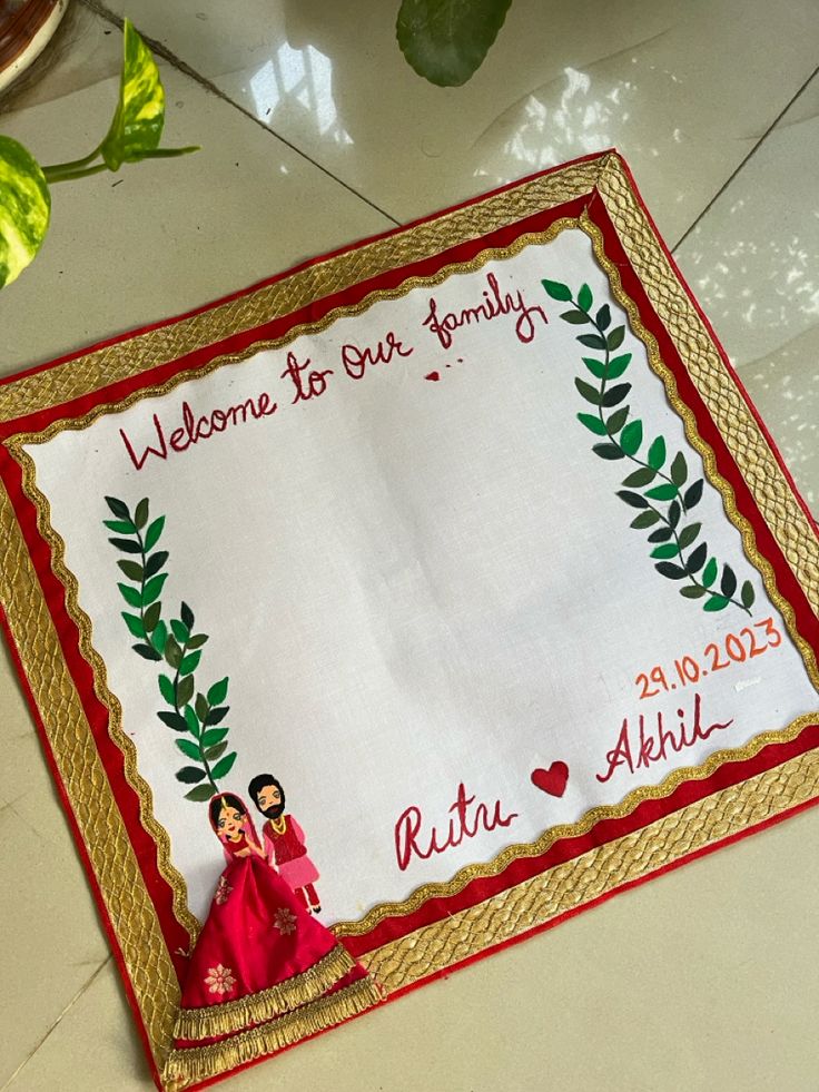 a welcome mat with an image of two women in red dresses and gold trimmings