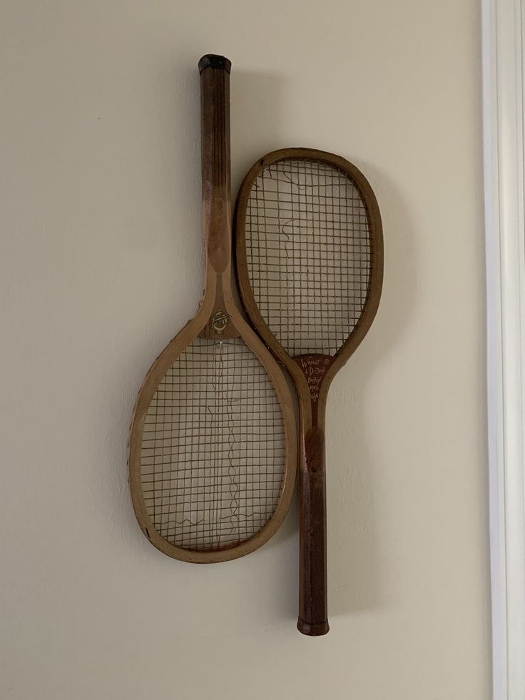 two tennis rackets hanging on the wall