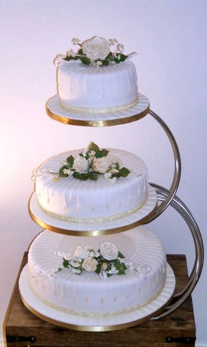 three tiered wedding cake with white flowers on top