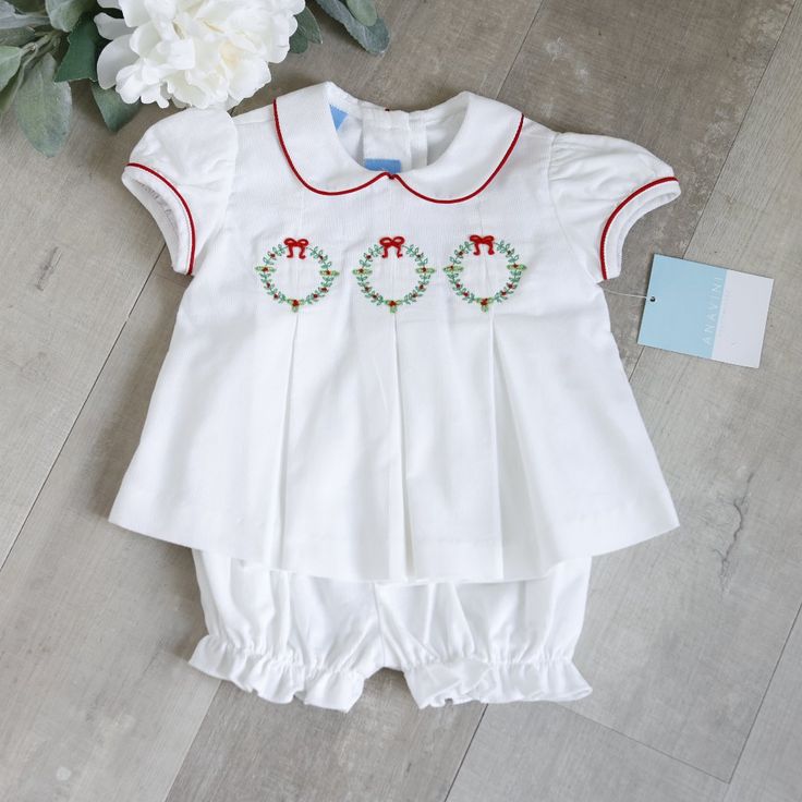 This Two Piece White Corduroy Set Is Traditional And Super Sweet! The Outfit Is Done In A Pin Wale Corduroy, Making It Super Soft. The Top Has A Peter Pan Collar Trimmed In A Red Piping. The Short Puff Sleeves Are Also Trimmed In A Red Piping. The Bodice Has Green And Red Accents With Red Bows Embroidered Across The Front. Just Below The Embroidery Is An Inverted Pleat That Falls To The Hem. The Back Has A Button Closure. The Matching White Bloomers/Diaper Cover Has An Elastic Waist And Elastic Big Red Hair, Corduroy Set, White Bloomers, Harley Davidson Baby, Red Hair Bow, Clothes Board, Embroidery Boutique, Girl Sweat, Holiday Outfits Christmas