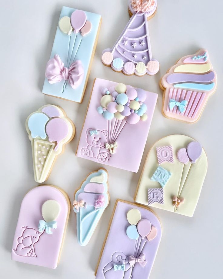 decorated cookies are arranged on a white surface