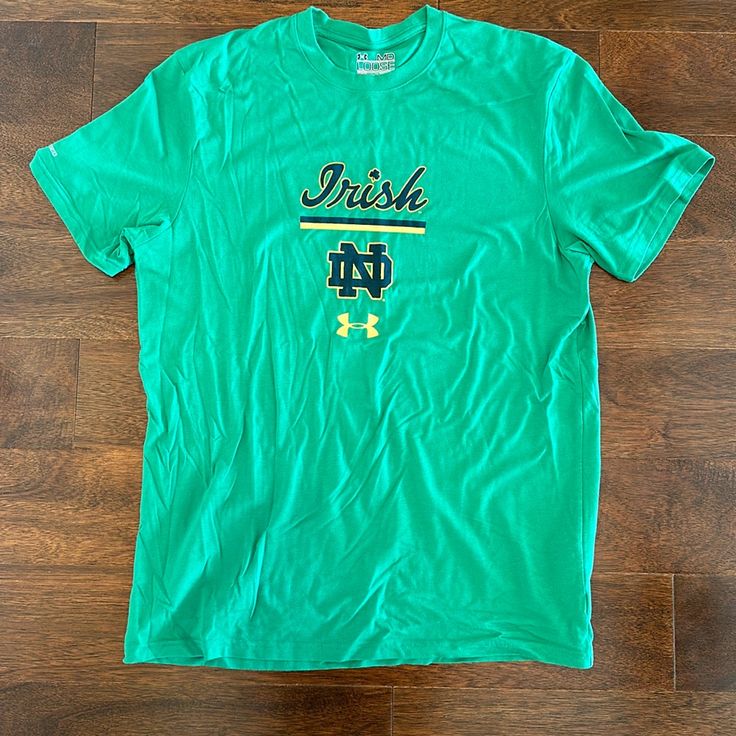 a green irish t - shirt sitting on top of a wooden floor