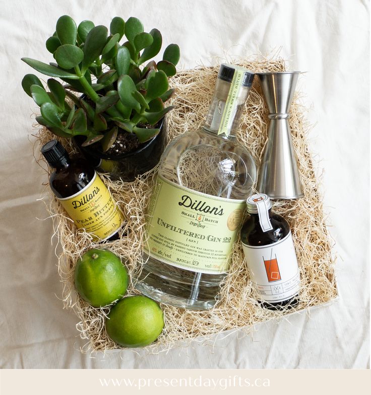 an assortment of alcohol and condiments in a gift box on a white sheet