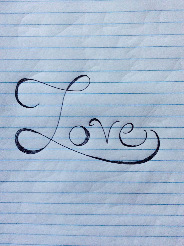 the word love written in cursive writing on lined paper