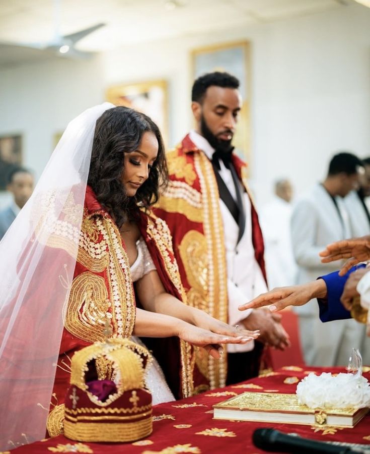 the bride and groom are exchanging their wedding rings