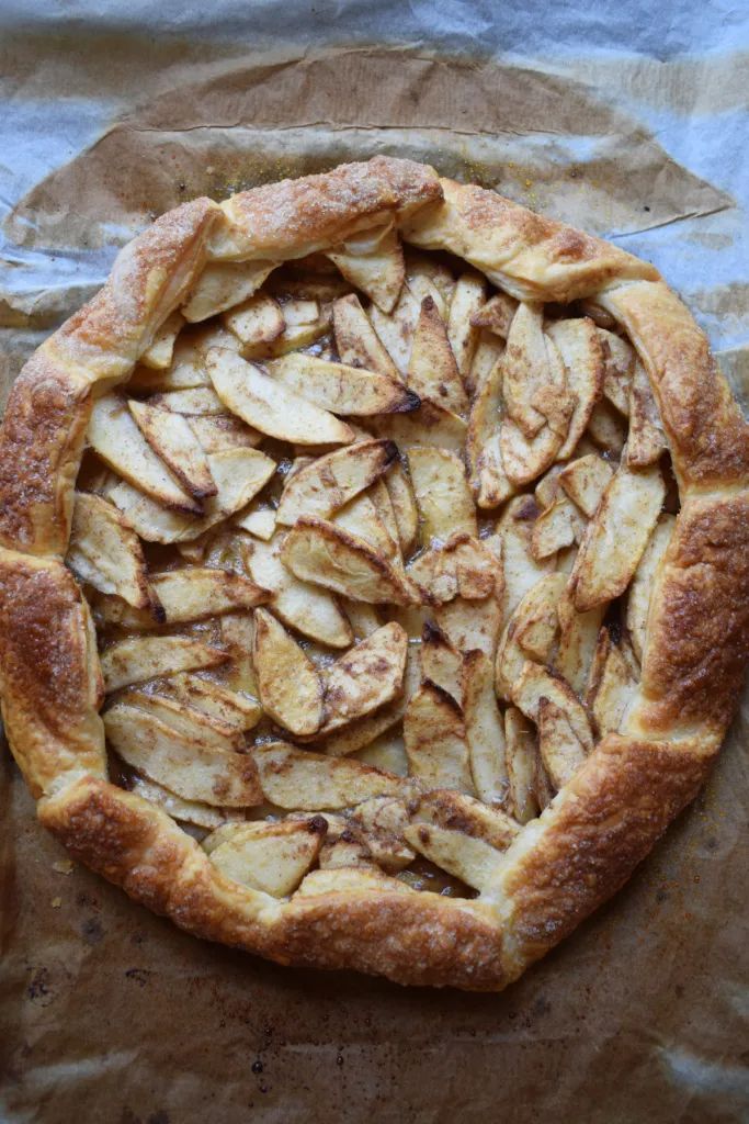 an apple pie is shown on top of wax paper