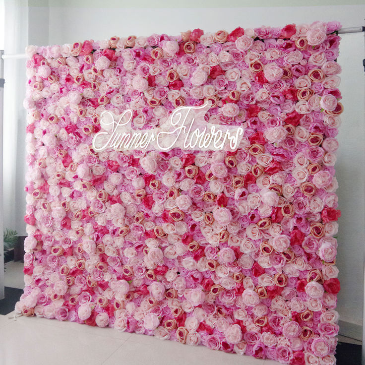 a pink flower wall with the word june flowers written on it