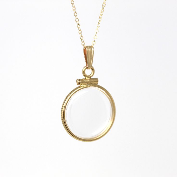 Timeless handcrafted brand new 14k gold filled empty shaker locket necklace! This classic pendant is dime sized with coin style bezels, and clear lucite covers. The round charm is shown modeled on a brand new 14k gold filled 20" chain, and is ready to be filled with your favorite gemstones, photos or keepsakes. An incredible piece of brand new jewelry, ready to hold your special findings!  ERA - Brand New METAL / MATERIAL - 14k gold filled locket, 14k gold filled chain, lucite clear covers, 1 screw (can be open and closed with a small screwdriver) MARKINGS / HISTORY - Bail is marked "1/20 14K G.F." on inside, chain is marked "14/20 G.F."    CONDITION - Excellent handcrafted brand new condition. The locket can be securely opened and closed with a small screw driver, such as ones intended fo Heirloom Necklaces With Charms, Heirloom Round Charm Necklaces, Gold Round Locket Necklace With Charms, Heirloom Necklace With Round Pendant Charms, Heirloom Charms Round Pendant Necklace, Antique 14k Gold Necklace With Charms, Round Locket Charm Necklaces, Brass Locket Charm Necklace, Brass Round Locket Charm Necklace