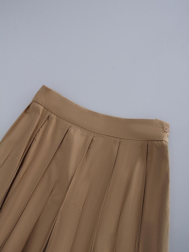 This Cotton Pleated Skirt-Tan is a must. The classic pleated design adds a touch of sophistication, making it perfect for both casual and formal occasions. Elegant Pleated Tennis Skirt For Spring, Pleated Skort For Office In Spring, Spring Office Wear Pleated Skort, Elegant Summer Skort In Solid Color, Elegant Mini Skort In Solid Color, Classic Skirted Bottoms With Pleated Waist, Elegant Solid Color Mini Skort, Elegant Mini Skirt Skort, Elegant Spring Tennis Skirt With Lining