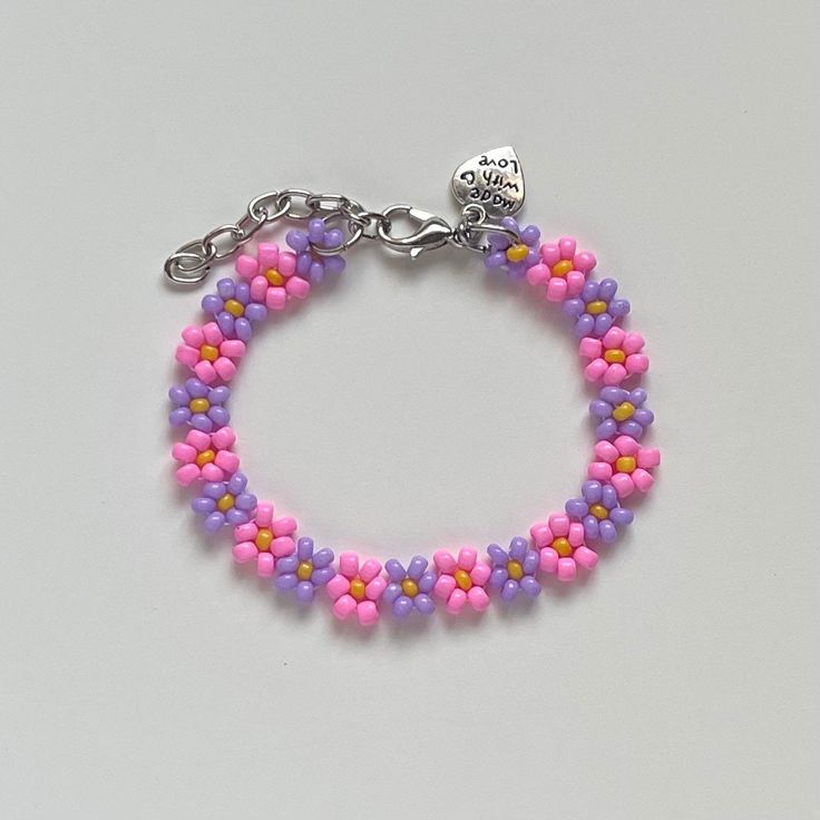 "Handmade Beaded Bracelet ✿ Made with glass seed beads and metal accents ✿ Pink, purple, yellow, and silver ✿ The bracelet has 1.5\" of extension chain" Pink And Purple Beaded Bracelet, Purple Beaded Chain Bracelets With Round Beads, Purple Beaded Chain Bracelet With Round Beads, Adjustable Purple Beaded Bracelet With Beaded Chain, Purple Beaded Chain Bracelet As Gift, Adjustable Purple Beaded Chain Bracelet, Adjustable Purple Beaded Chain Bracelets, Bohemian Purple Beaded Chain Bracelets, Purple Flower Shaped Beaded Bracelets