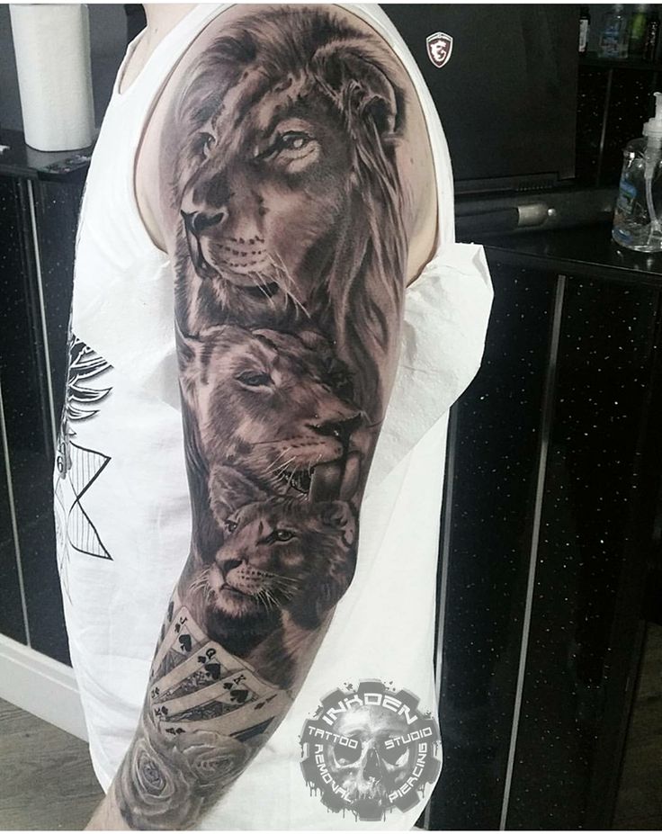 a man's arm with a lion and lions tattoo on the left side of his arm