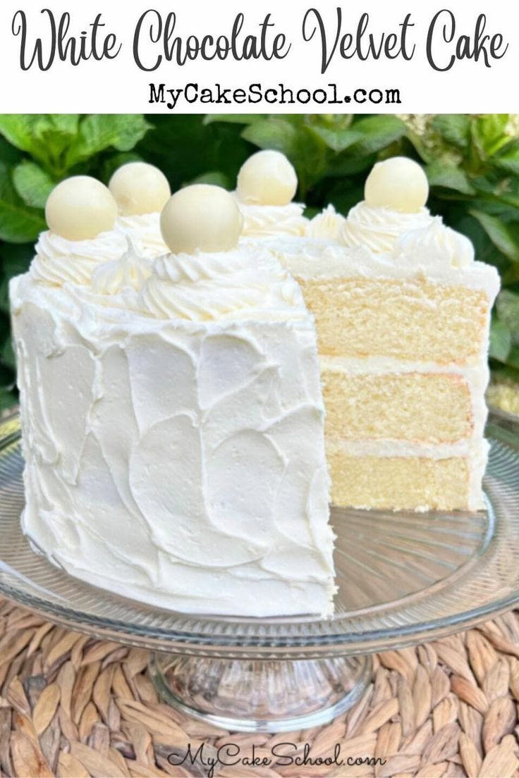 a close up of a cake on a plate with the words white chocolate velvet cake