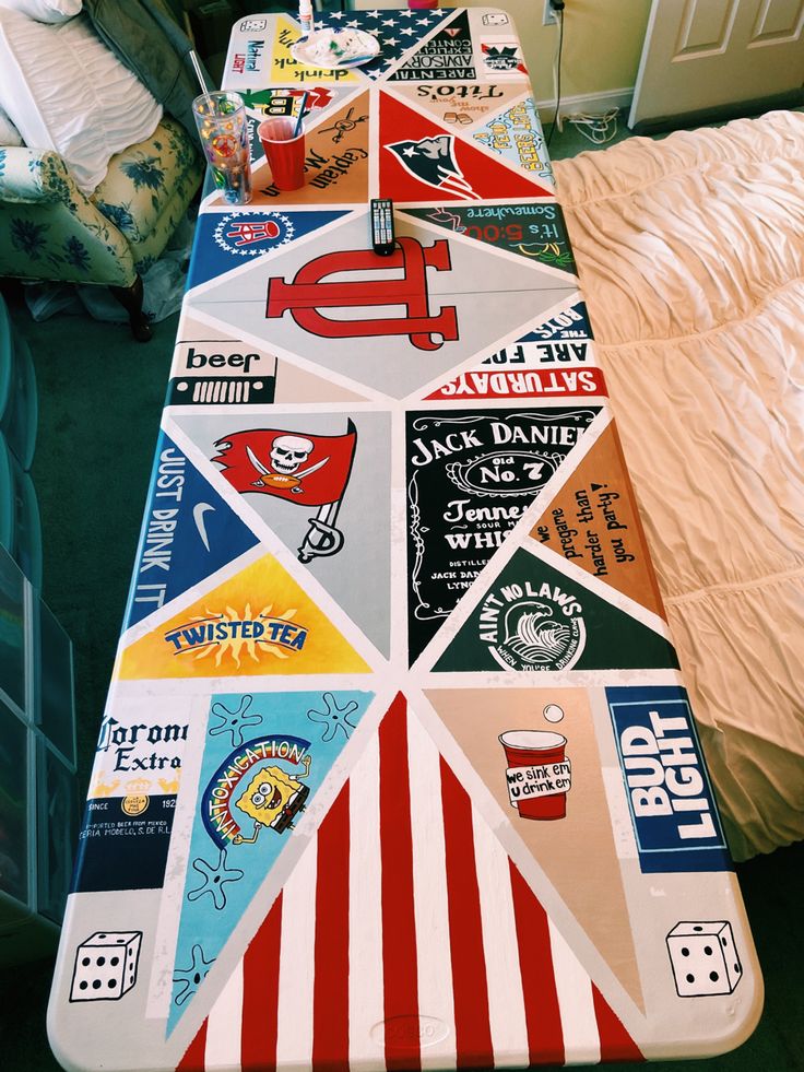 a long table covered in lots of stickers and logos on it's sides