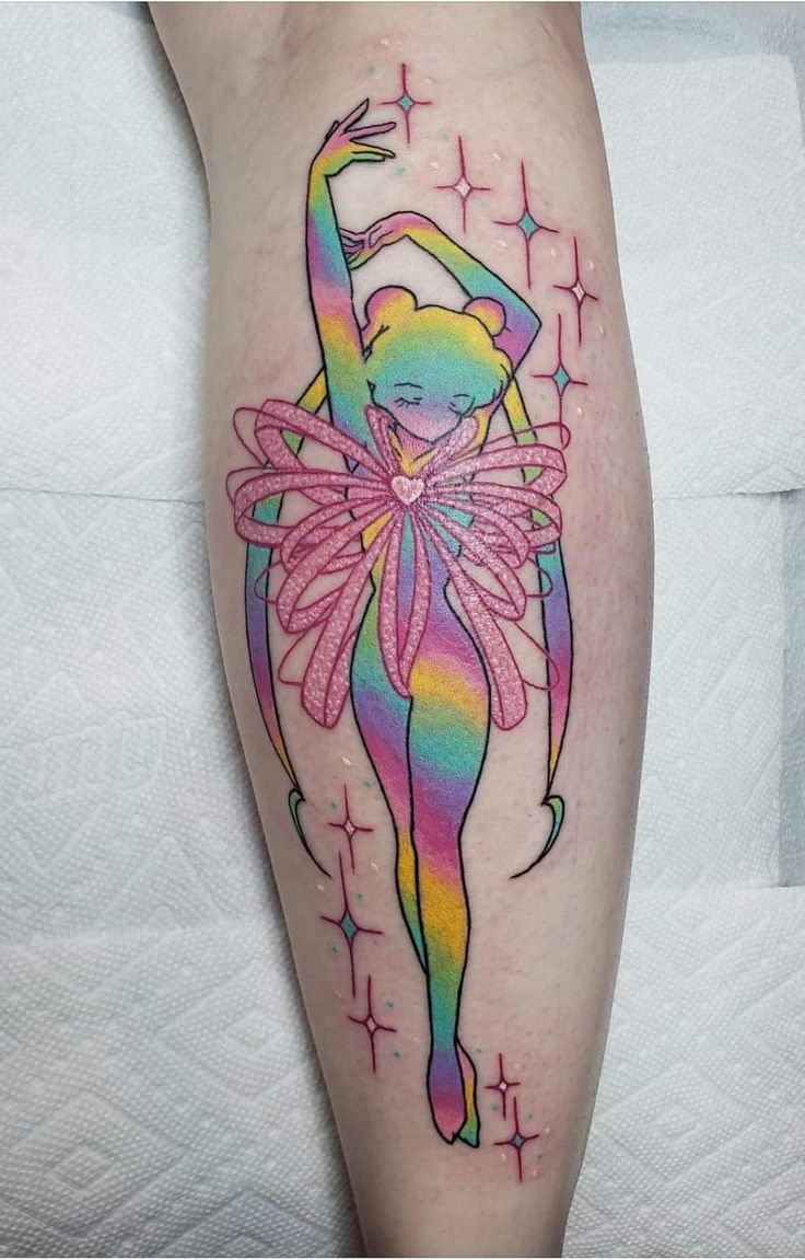 a colorful tattoo on the leg of a woman with a ballerina in her hand