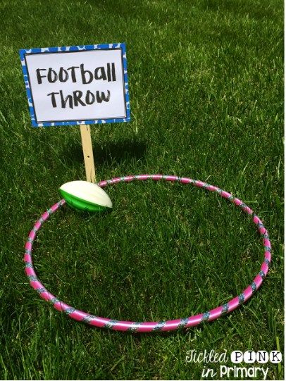 a sign that says football throw on top of a hula hoop in the grass