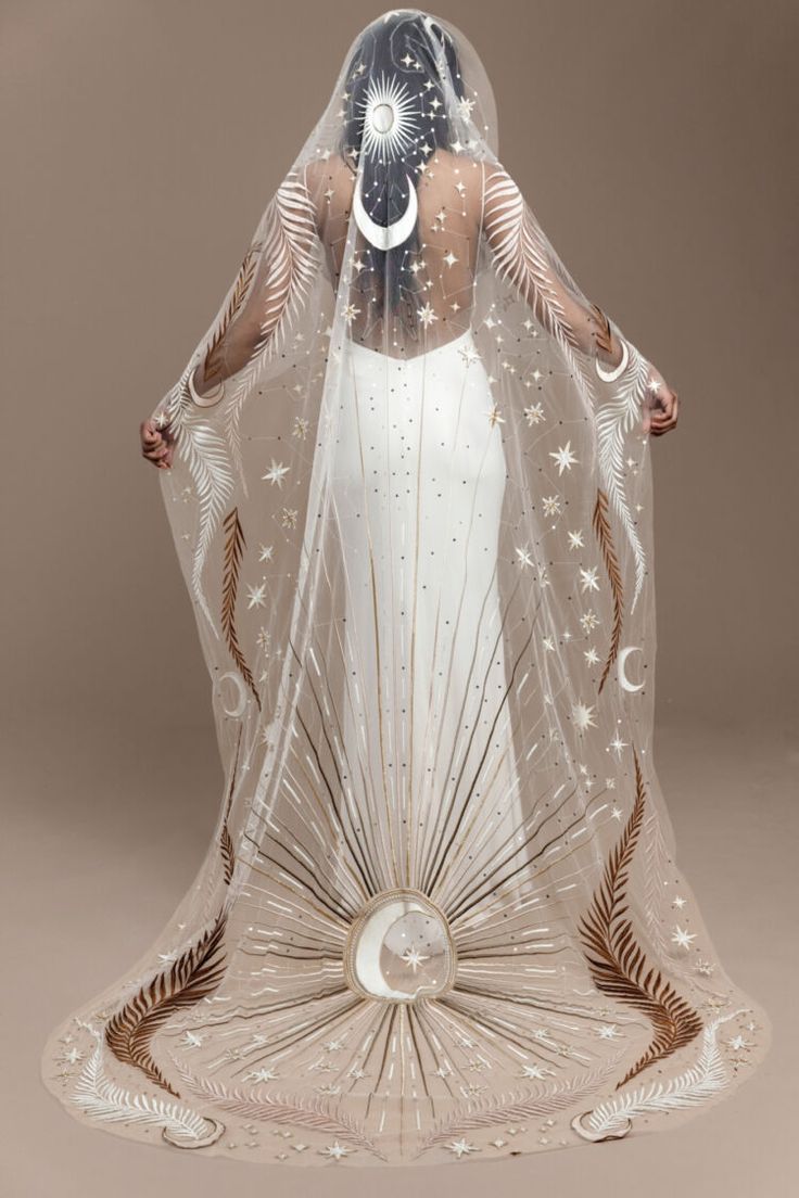 a woman wearing a veil with stars on it