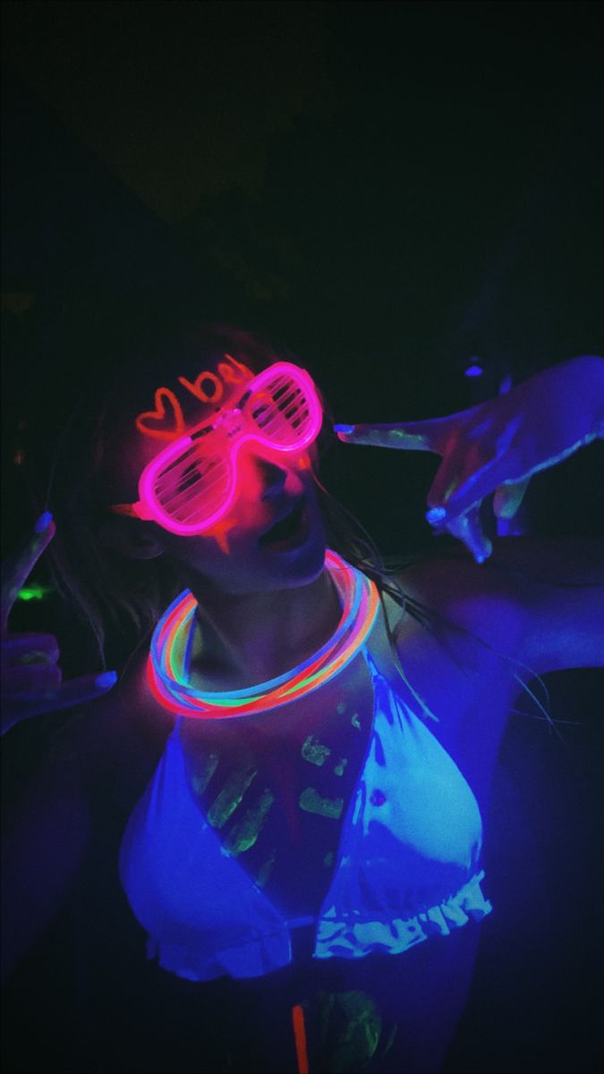 a woman with neon glasses on her face