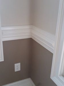 the corner of a bathroom with a toilet and window