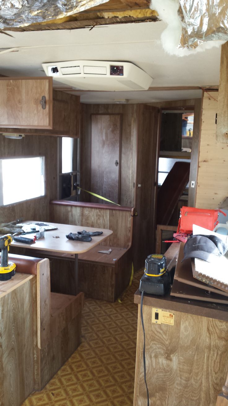 the inside of an rv with wood paneling