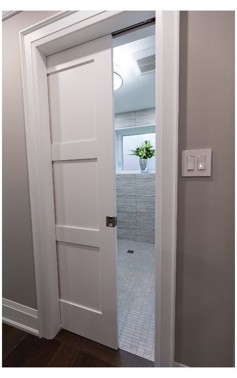 an open white door leading to a bathroom