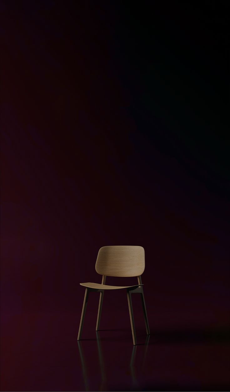 a wooden chair sitting on top of a dark purple floor next to a red wall