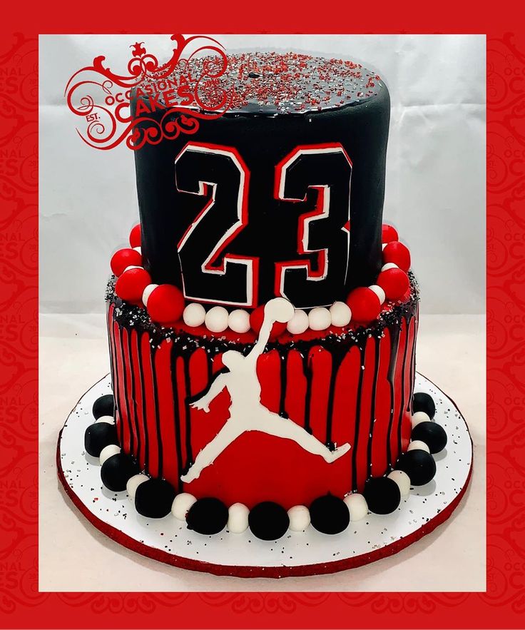 a red and black cake with the number 23 on it