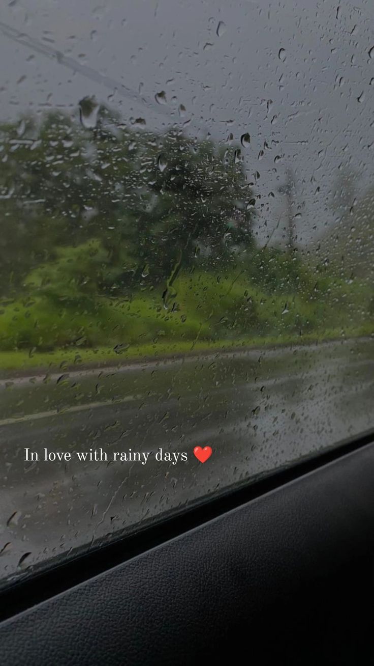 rain is falling on the windshield of a car