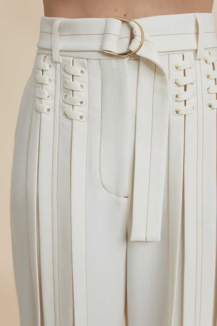 The Haywood Pant in Coconut are designed to be fitted at the waist and relaxed toward the hem. An updated suiting silhouette featuring lace up detail, soft pleats through the legs, contrast top stitching and a luxurious d-ring belt with gold hardware. Pair back with the Haywood Jacket for a complete look. - High waist fit - Full length pant - Front fly closure - Detachable belt - Vertical pleating Model is 180cm / 5'10″ wearing an AU 8 / US 4 Composition: 80% Polyester, 16% Viscose Rayon, 4% Ela Body Shape Style Guide, Clothing Hardware, Body Shape Outfits, Pear Body Shape Fashion, Pear Body Shape Outfits, Luxury Tops, Zipper Fashion, Pear Body, Pear Body Shape