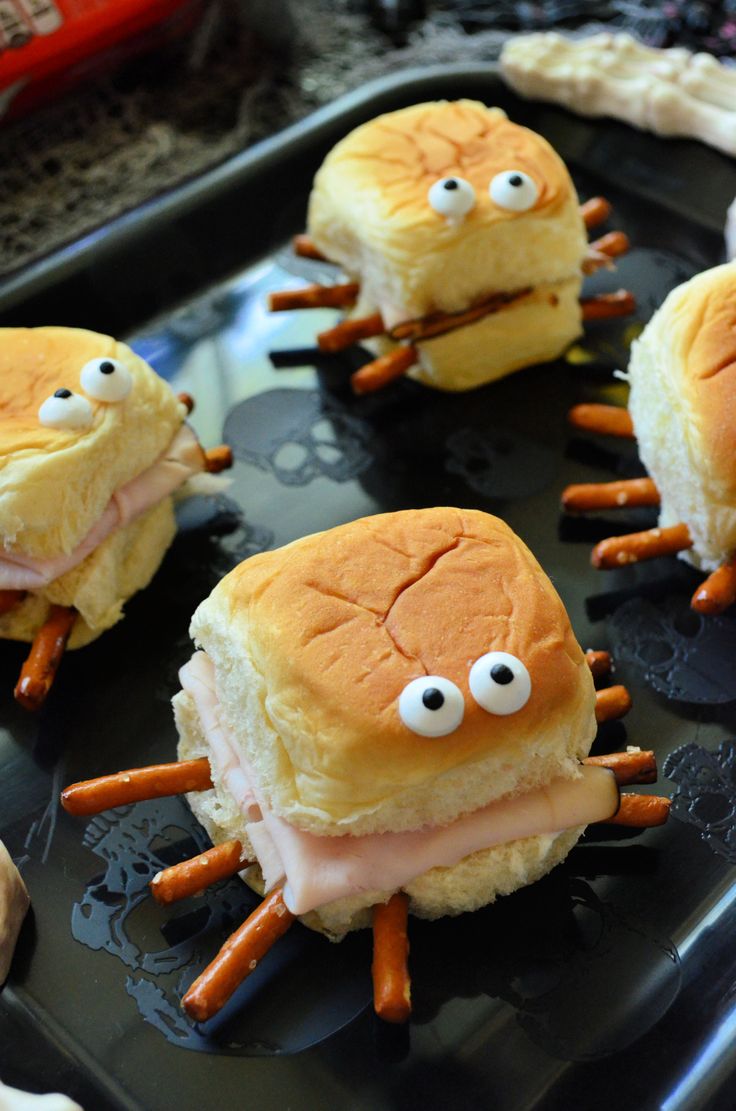 some sandwiches with googly eyes and carrots on them are ready to be eaten