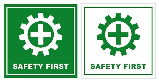 two safety first signs, one with a gear wheel and the other with a cross