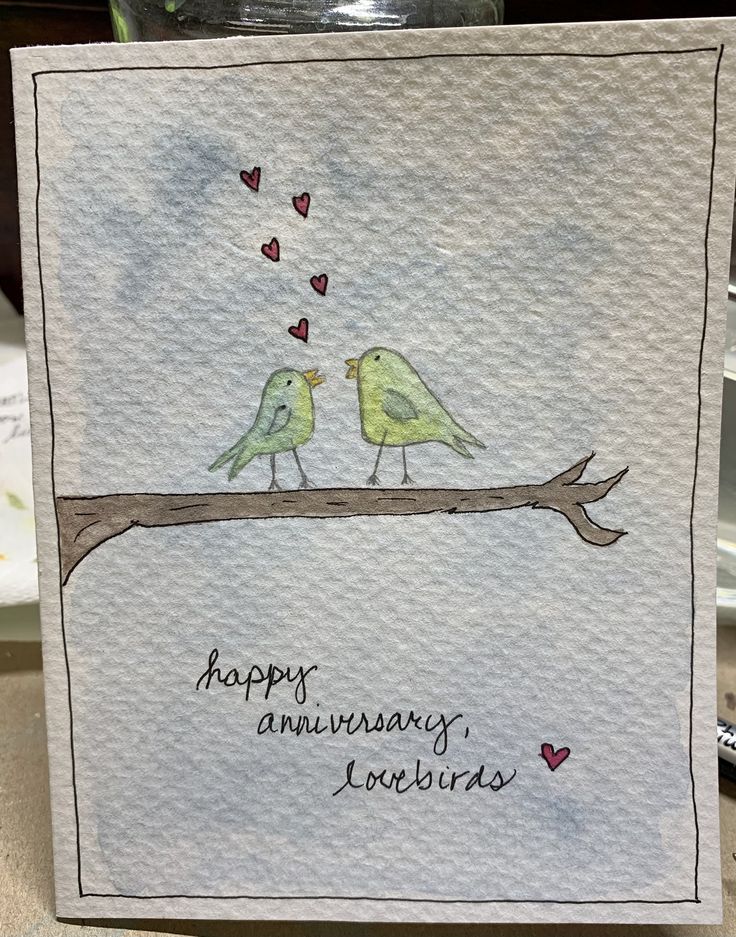 two birds are sitting on a branch with hearts in the sky and happy anniversary lovebirds