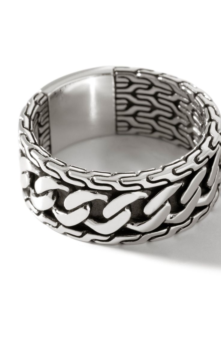 This sterling silver band ring is handcrafted with signature chain-link engraving. Sterling silver Imported Classic White Gold Chain Ring, Silver Sterling Silver Chain Ring, Sterling Silver Chain Ring In Silver, Classic Silver Rings With Chain Detail, Classic Silver Ring With Chain Detail, Modern Silver Chain Link Ring, Luxury Silver Chain Ring As Gift, Classic Silver Link Rings, Luxury White Gold Sterling Silver Chain Ring