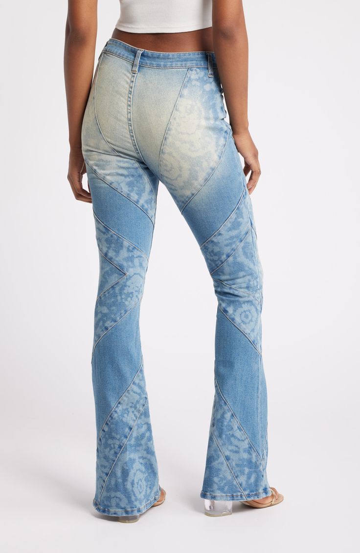 A tie-dye wash and angled seams bring eye-catching appeal to these flared jeans cut from low-stretch denim. 31" inseam; 23" leg opening; 10" front rise; 15" back rise (size 29) Zip fly with button closure Front scoop pockets; back patch pockets 69% cotton, 30% polyester, 1% spandex Machine wash, tumble dry Imported Fitted Denim Flares With Frayed Hem, Distressed High Rise Fitted Flares, Fitted Distressed Denim Flares, Distressed High-rise Fitted Flares, Fitted High Rise Distressed Flares, Fitted Faded Cotton Flare Jeans, Distressed Fitted Flares, Distressed Fitted Flares For Spring, Trendy Fitted Distressed Flares