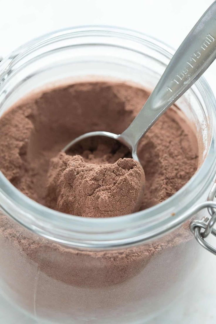 a spoon in a jar filled with chocolate powder